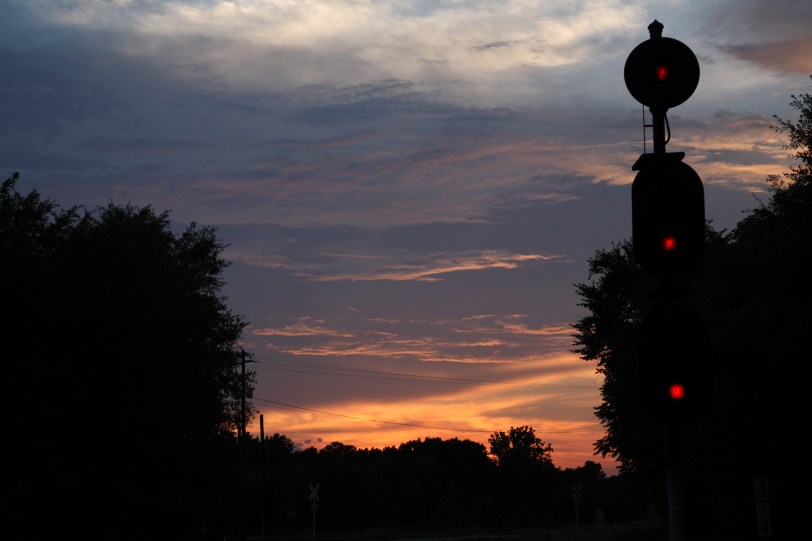 sunset by railroad signal